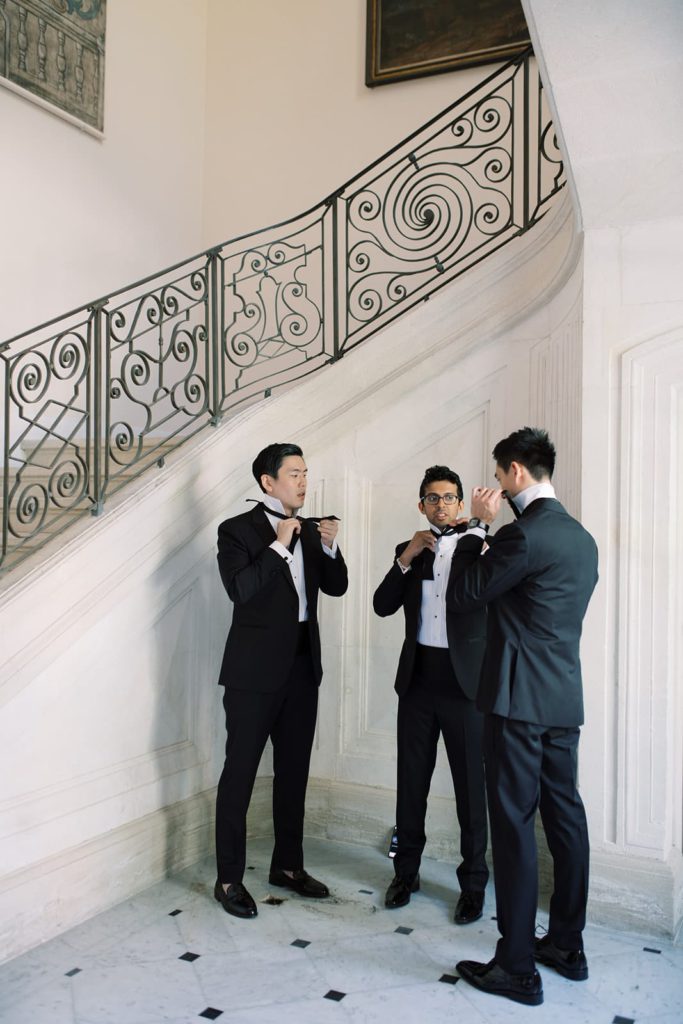 Groomsmen getting ready at a wedding at Chateau de Tourreau