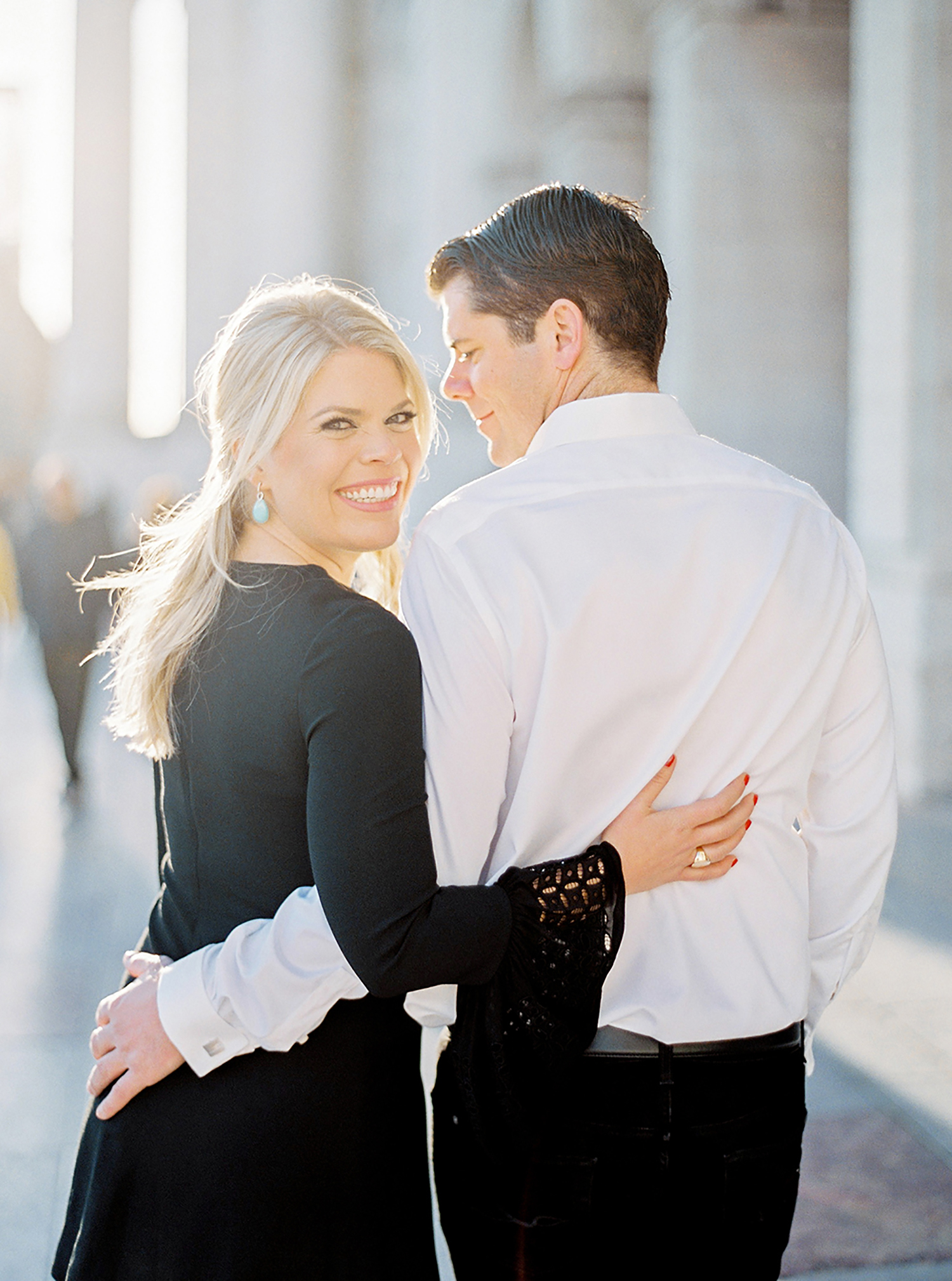 Engaged couple smiling in Lisbon